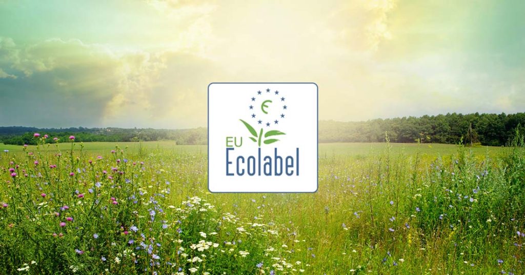 EU Ecolabel logo with a background of green fields and a sunny sky.