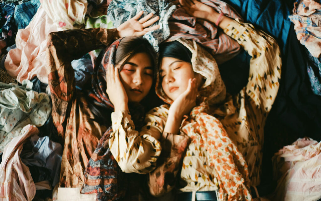 Women on a pile of clothes